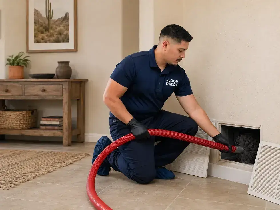 Floor Daddy technician cleaning a residential air duct in an Arizona home