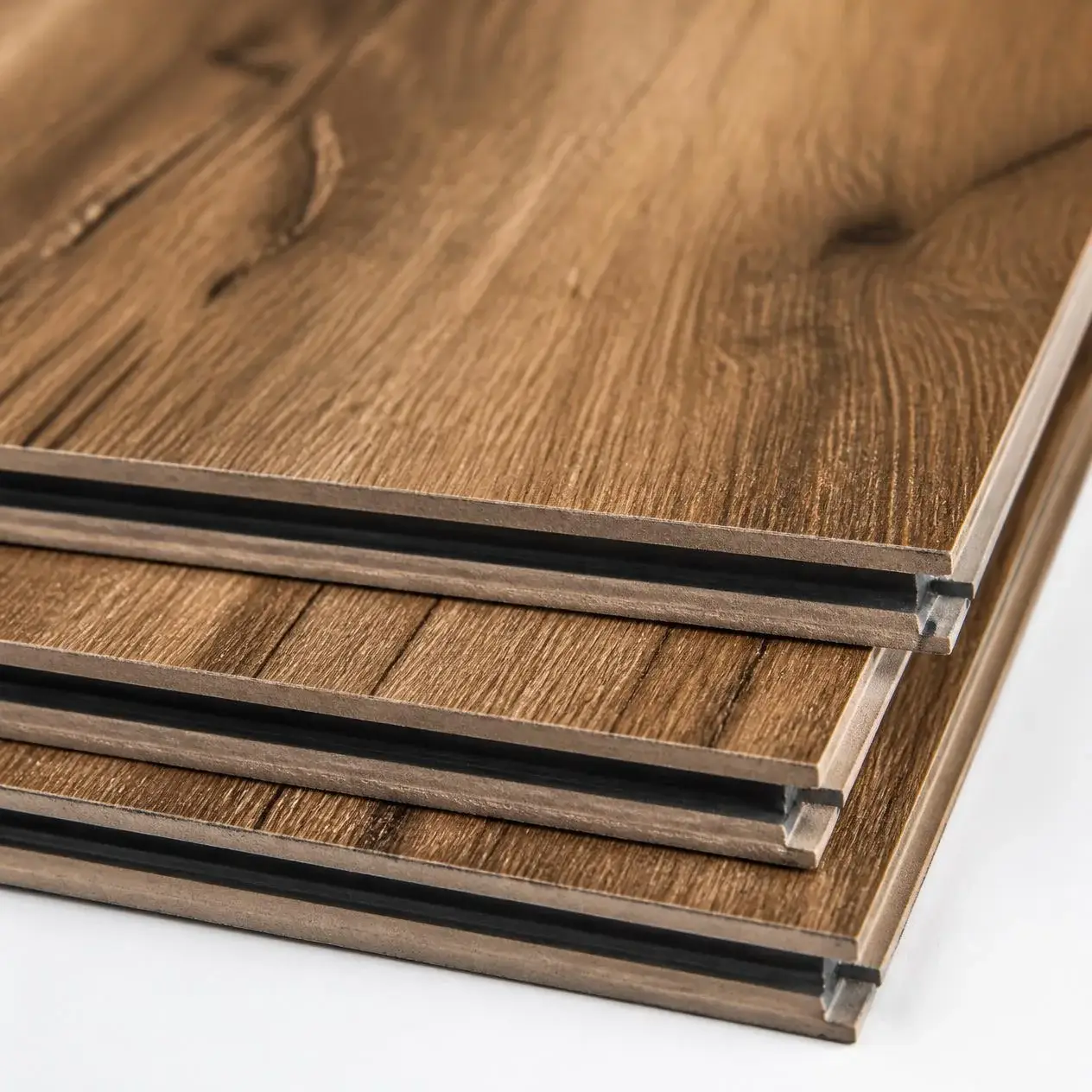 Thick AC4-rated laminate planks in a hickory look showing deep embossed texture and click-lock edges