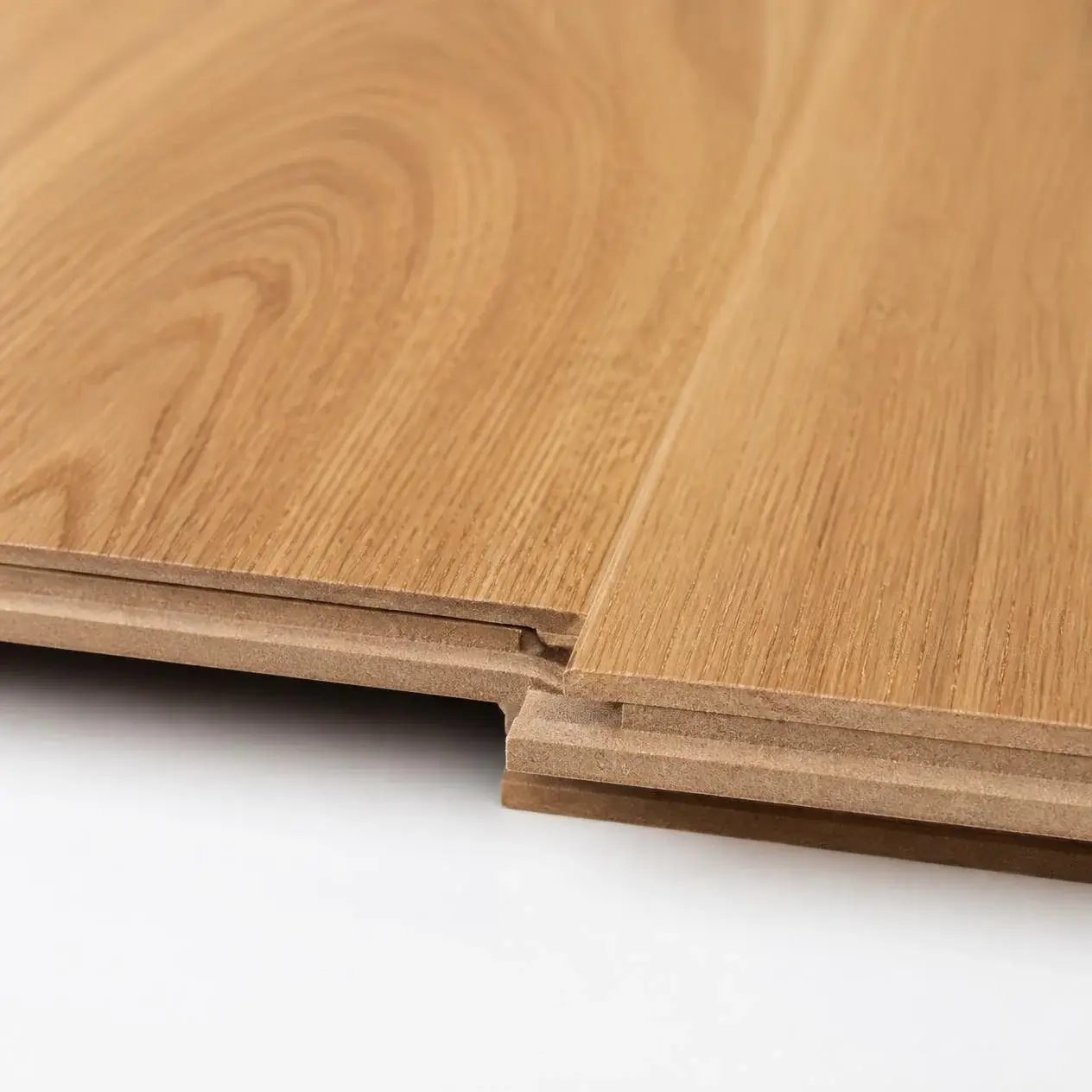 Premium wide laminate planks in a natural European oak look, laid flat to show the thick HDF core and click-lock ends