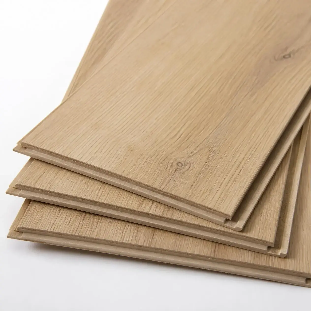 Standard laminate planks in a light natural oak look with square edges and click-lock profiles